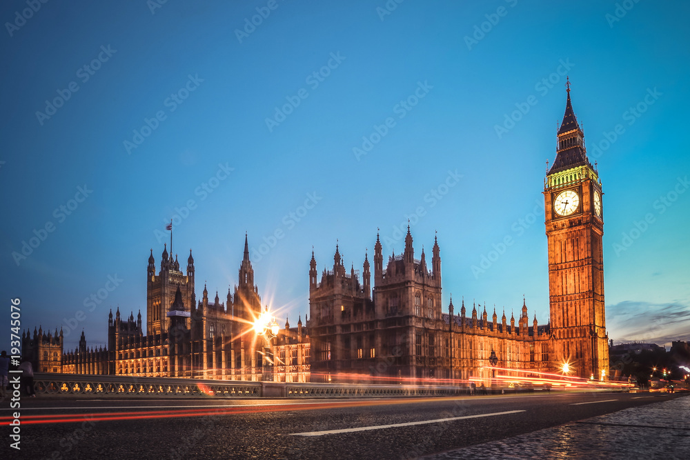 London famous view. Long exposure shot of Big Ben, Westminster bridge and House of parliament. Evening scene.