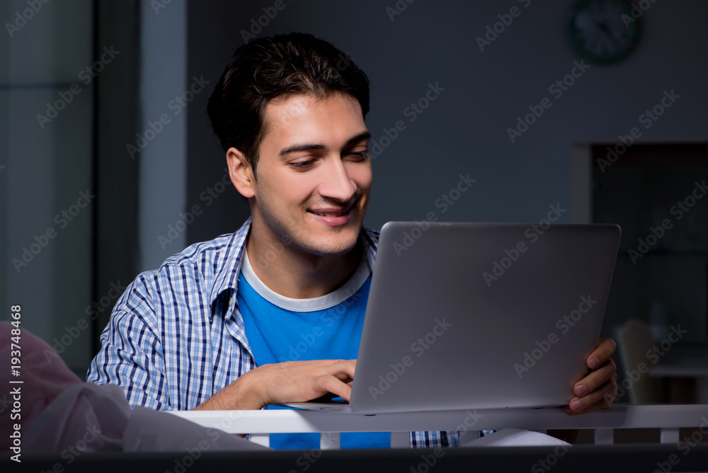 Young student doing homework and looking after newborn baby Young student doing homework and looking after newborn baby