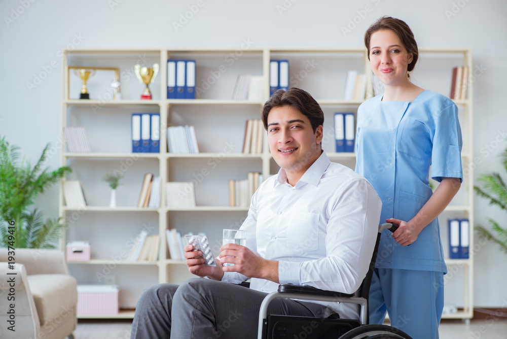 Disabled patient on wheelchair visiting doctor for regular check Disabled patient on wheelchair visiting doctor for regular check