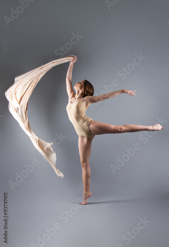 Fototapeta Naklejka Na Ścianę i Meble -  beautiful young girl dancing with cloth. Flying fluttering fabric.