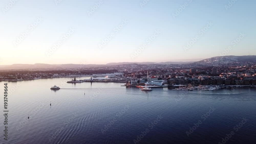 Aerial shot of two ferry boats in Oslo fjord, Norway, moving away from camera towards the sunset Aerial shot of two ferry boats in Oslo fjord, Norway, moving away from camera towards the sunset