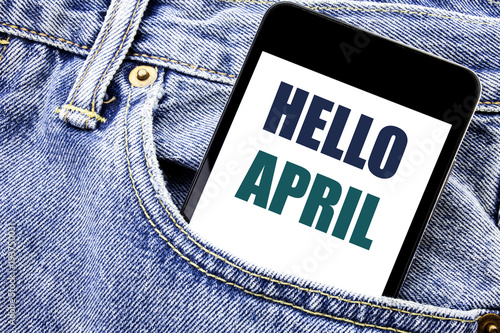 Conceptual hand writing text caption inspiration showing Hello April. Business concept for Spring Welcome Written phone mobile phone, cellphone placed in the man front jeans pocket. photo