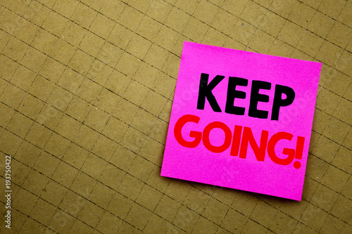 Handwritten text caption showing Keep Going. Business concept writing for Go Moving Forward Letting written on sticky note paper on the yellow background.