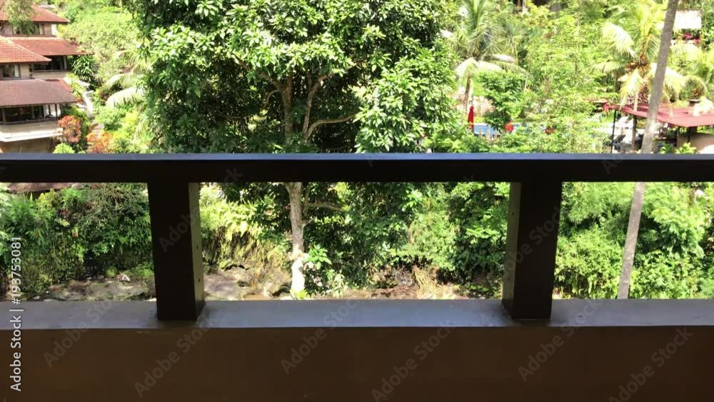 Couple of wooden chairs and table on a tropical jungle rainforest background. Tropical resort, Bali island. 4K soft motion. Couple of wooden chairs and table on a tropical jungle rainforest background. Tropical resort, Bali island. 4K soft motion.
