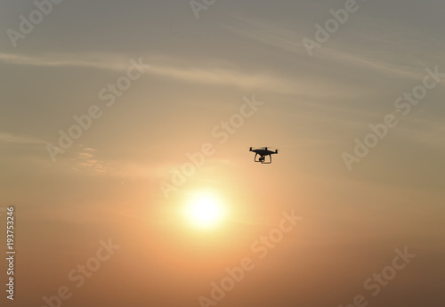 Quadrocopters silhouette against the background of the sunset