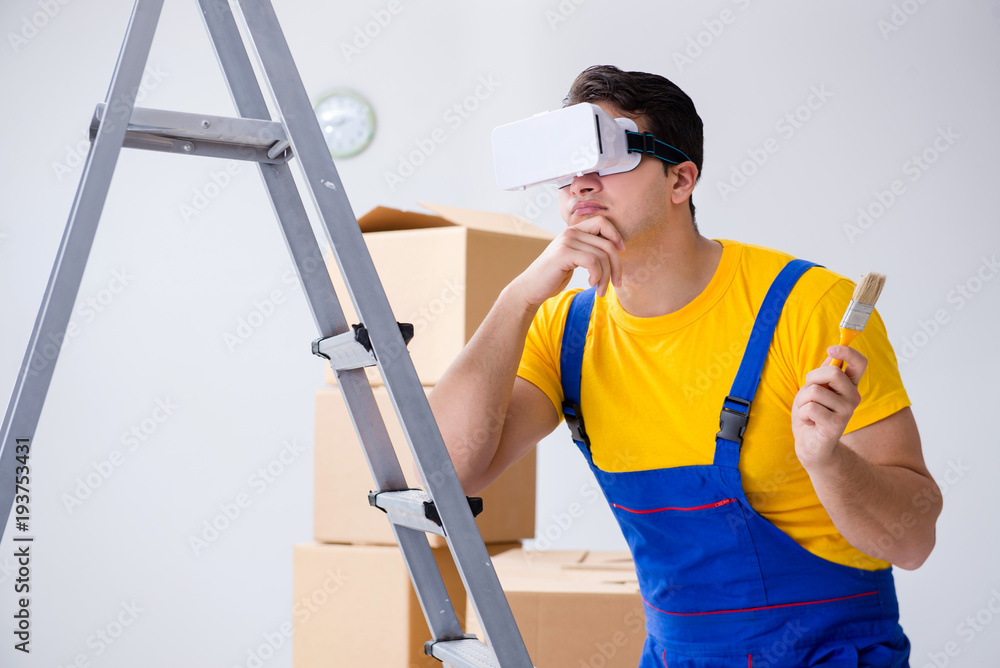 Painter contractor working with virtual reality goggles Painter contractor working with virtual reality goggles