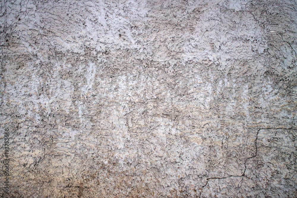 Cement plastered wall. A crack in the wall. Cement plastered wall. A crack in the wall.