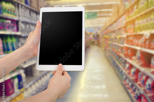 human hand hold and scanning fingerprint smart phone, tablet, cellphone on products shelf store. concept of shopping online and authentication permission.