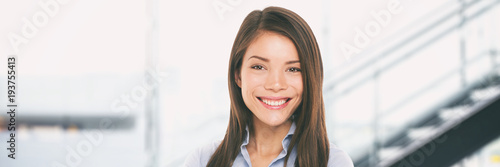 Asian woman smiling on business office background banner. Portrait of multiracial Chinese Caucasian woman confident smiling at camera panorama.