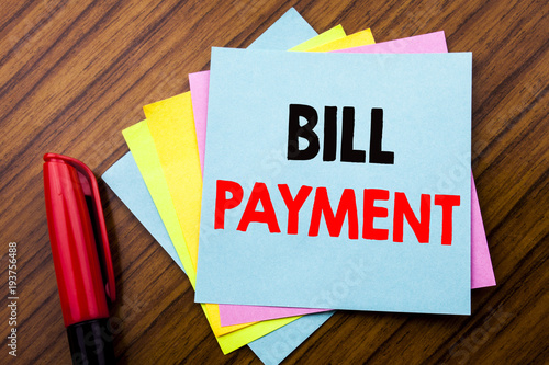 Handwriting Announcement text Bill Payment.  Concept for Billing Pay Costs Written on sticky stick note paper with wooden background with space office view with pencil marker photo