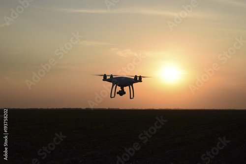 Quadrocopters silhouette against the background of the sunset