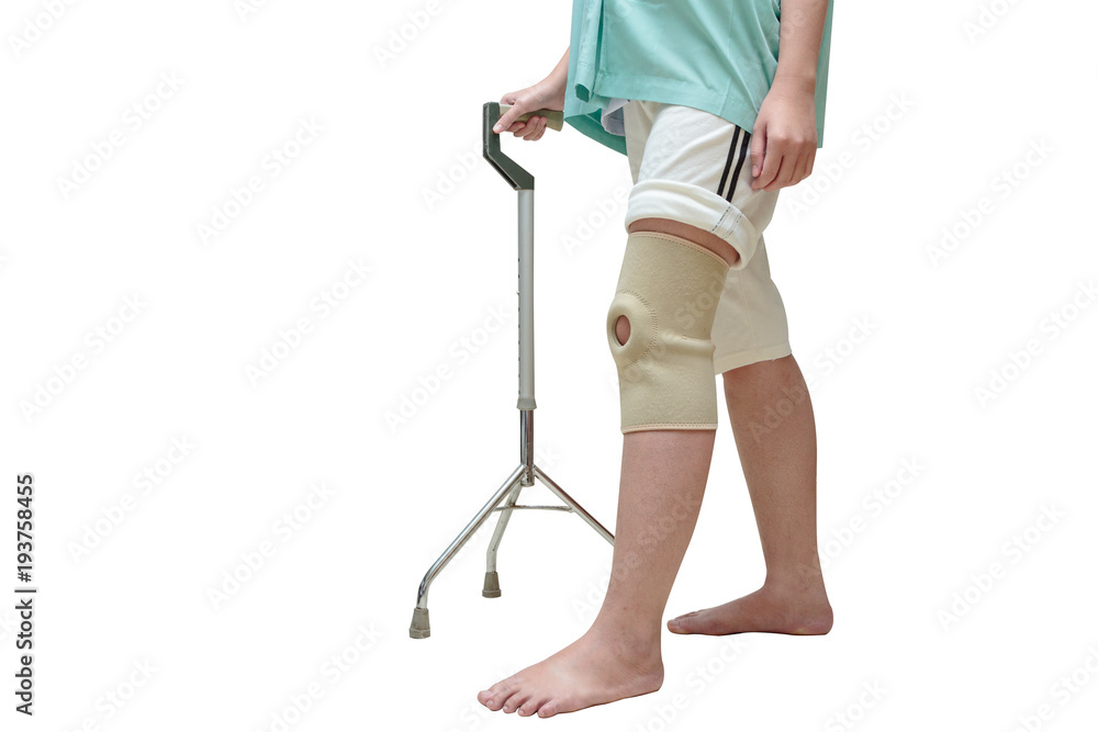 Woman in knee support walking on cane ,isolate on white Woman in knee support walking on cane ,isolate on white
