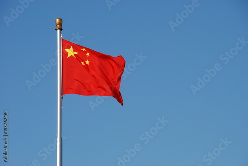 Chinese flag waving in the wind with clear blue sky