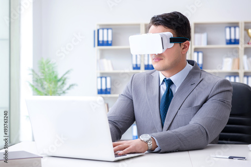 Businessman with virtual reality glasses in modern technology co