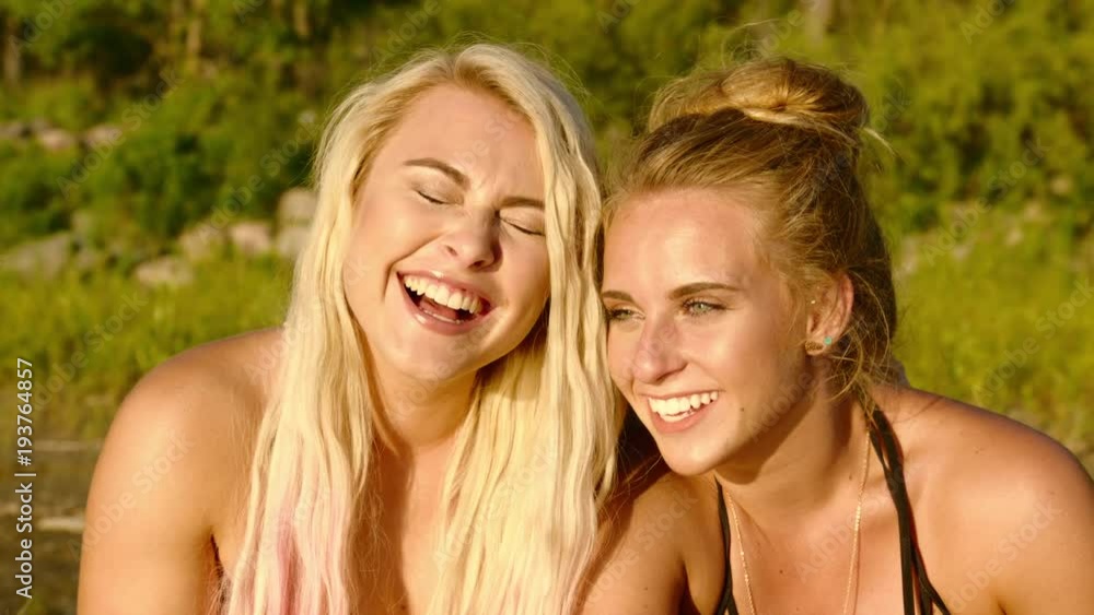 Close up of young female friends laughing together Close up of young female friends laughing together