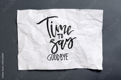 Time to say goodbye. Handwritten text on white crumpled paper. Inspirational quote.