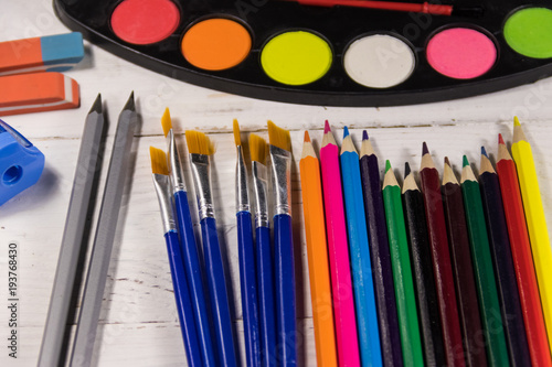 Set of drawing tools on white wooden background