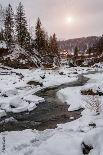 Winter landscape. Mountain river flows from the rocks. Snow and mountain river © ryabuha_nazar