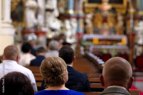 People are sitting in the church during mass © wideonet