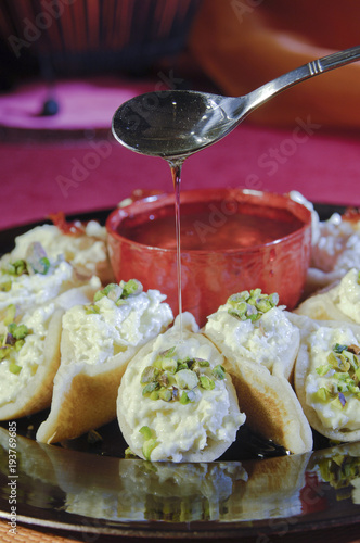 Pouring Syrup on Asafeer, Arabic Sweets for Ramadan and Eid photo