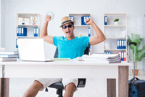 Businessman preparing for vacation in the office