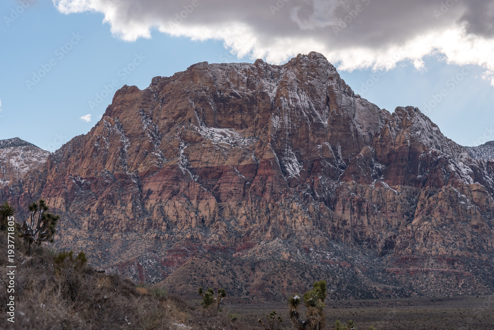 Red and Orange rocky mountain formation with snowy top