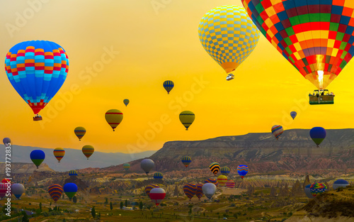 Sunset Hot air balloons landing in a mountain Cappadocia Goreme National Park Turkey tourist attraction