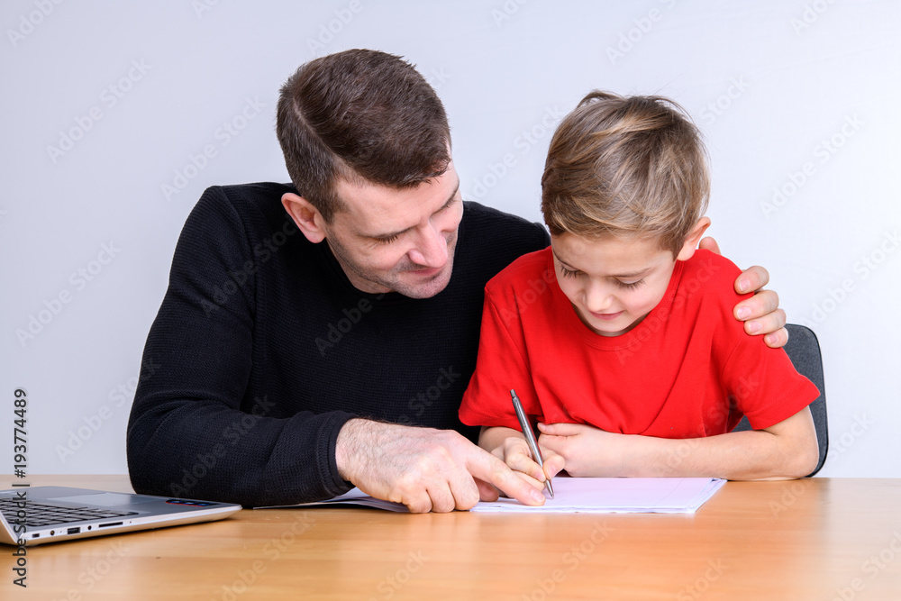 father helping his son with homework father helping his son with homework