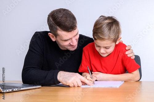 father helping his son with homework
