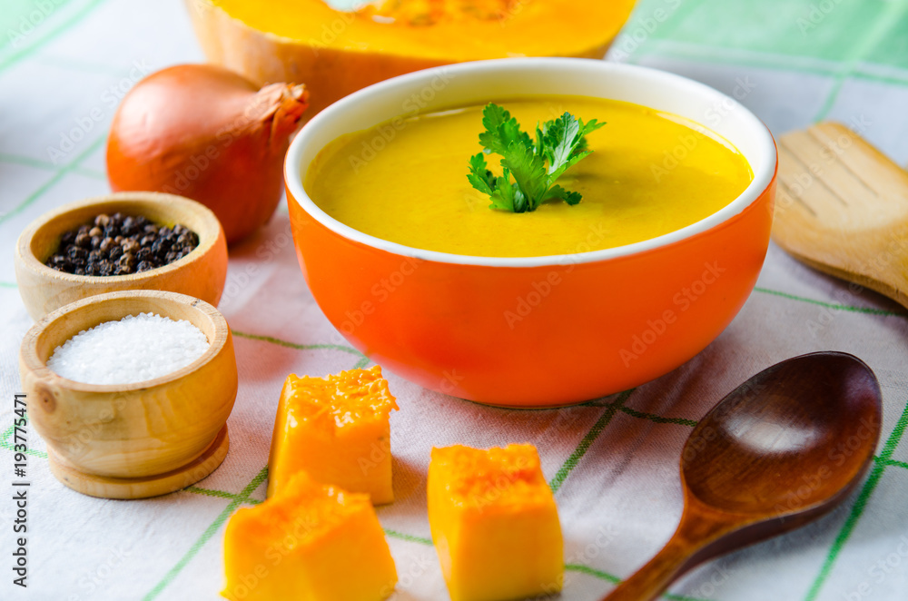 Pumpkin soup served on the table in bowl Pumpkin soup served on the table in bowl
