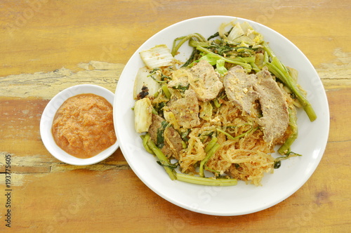 fried glass noodles with pork and vegetable on plate dipping sukiyaki sauce