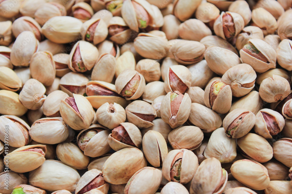 Pistachio Nuts Texture Background Top View. Pile of Fresh Green Pistachios, Roasted and Salted in Shell. Healthy Nuts with High Nutrition Ingredients, Close Up Pattern. Pistachio Nuts Texture Background Top View. Pile of Fresh Green Pistachios, Roasted and Salted in Shell. Healthy Nuts with High Nutrition Ingredients, Close Up Pattern.