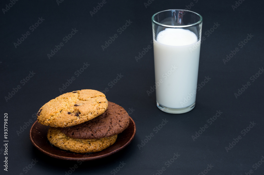 A variety of oatmeal cookies and a glass of milk. A variety of oatmeal cookies and a glass of milk.