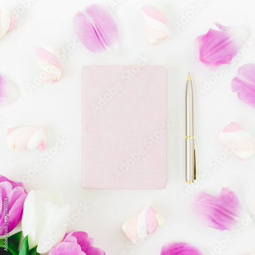 Pink tulips flowers and marshmallow with dairy and pen on white background. Flat lay, Top view. Tulip flower and candy