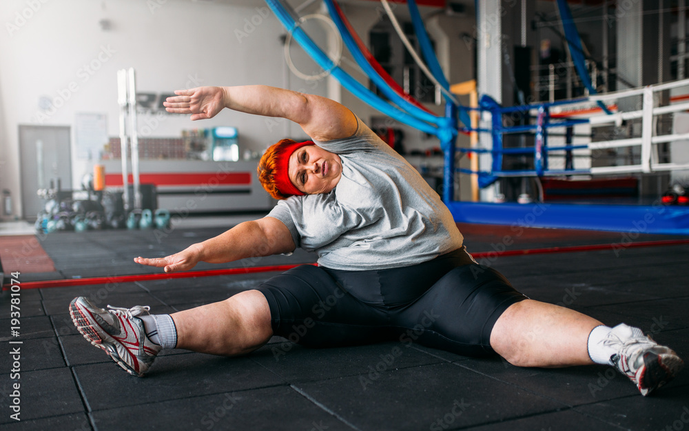 Fat woman exercises on the floor, workout in gym Stock Photo Adobe Stock