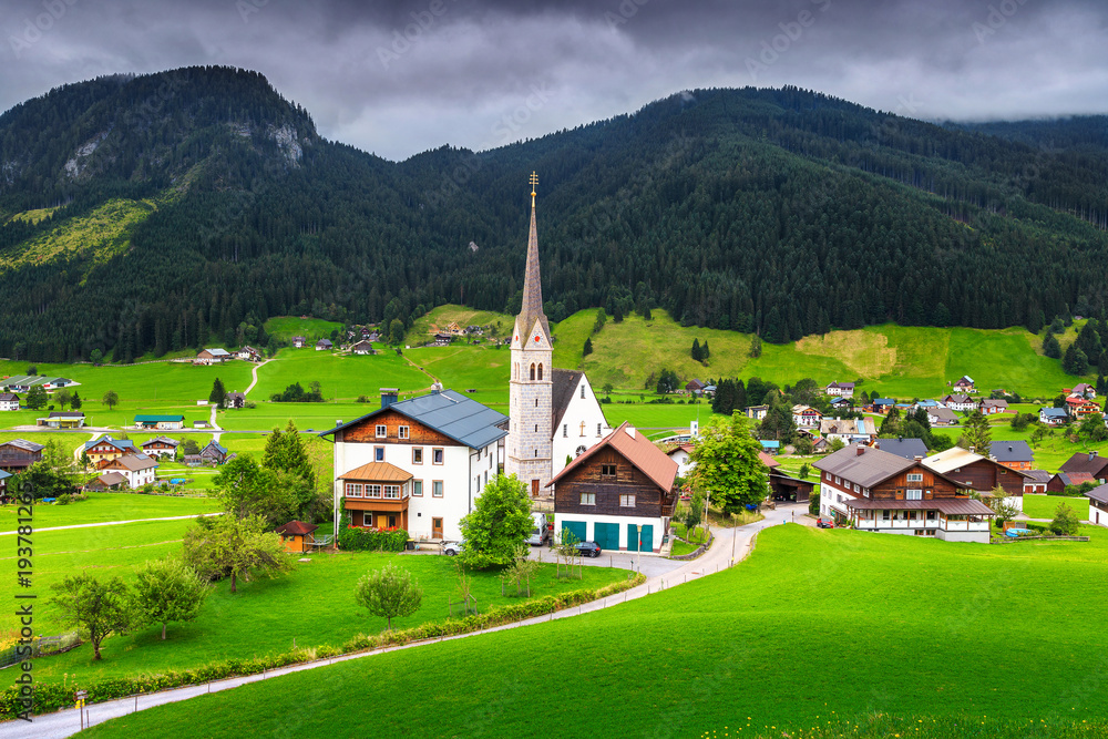 Spring alpine landscape with traditional houses and green fields, Austria