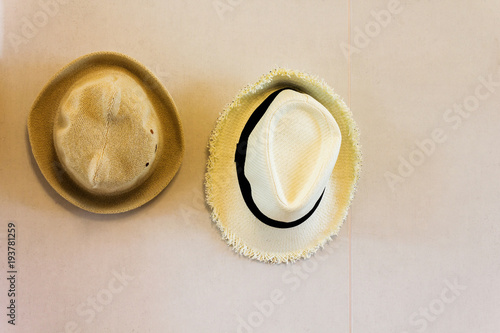 Couple hat of man and women hanging on the wall