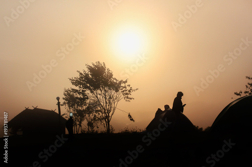 Obraz na plátně Silhouette dark man, hut and tree shadow in densely fog in winter morning with s