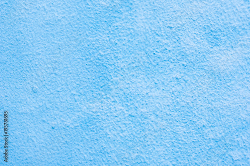 Background of a blue stucco coated and painted exterior, rough cast of cement and concrete wall texture, decorative coating