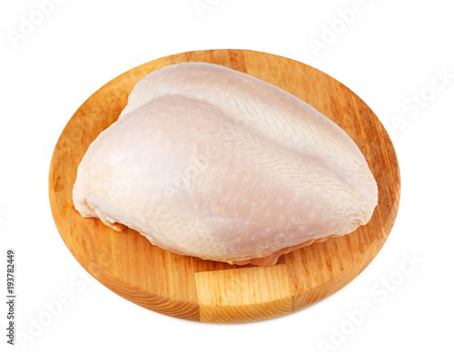 Raw chicken breast on the wooden board isolated on white background. photo