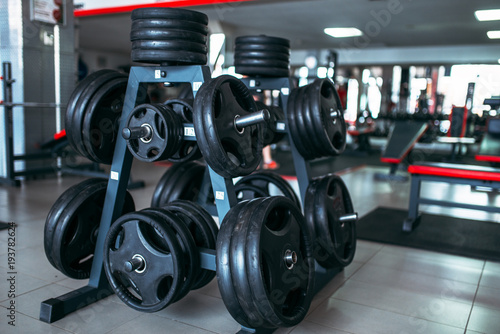 Weights for a bar, sport equipment in gym