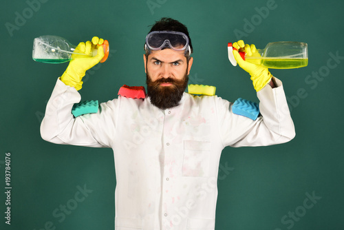 Cleaning service. Cleaning products. Sirious bearded man with cleaning products. photo