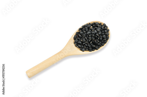 Organic Black beans seed on wooden spoon isolated on white background,top view