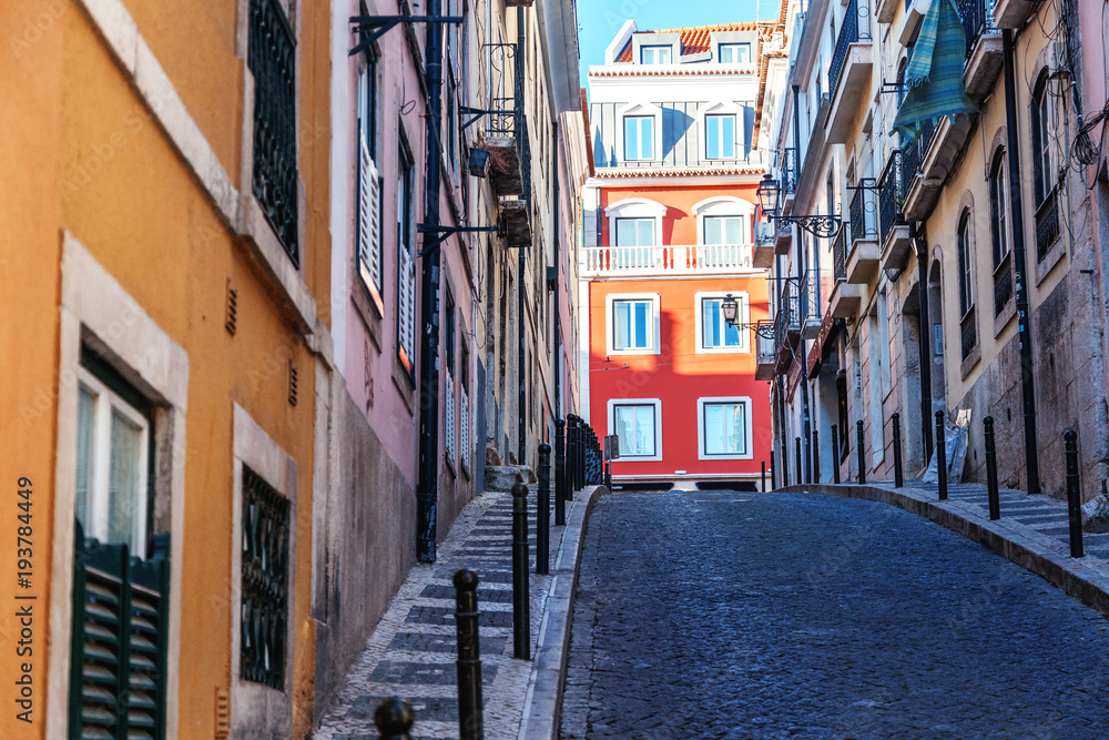 Fototapeta premium Lisbon, the capital of Portugal, narrow street in the historic old town center, image with retro toning