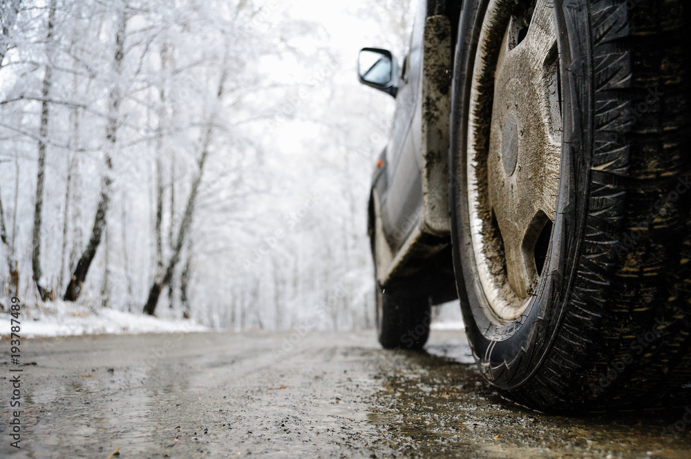 Closeup shot of wheel on the snow road Closeup shot of wheel on the snow road