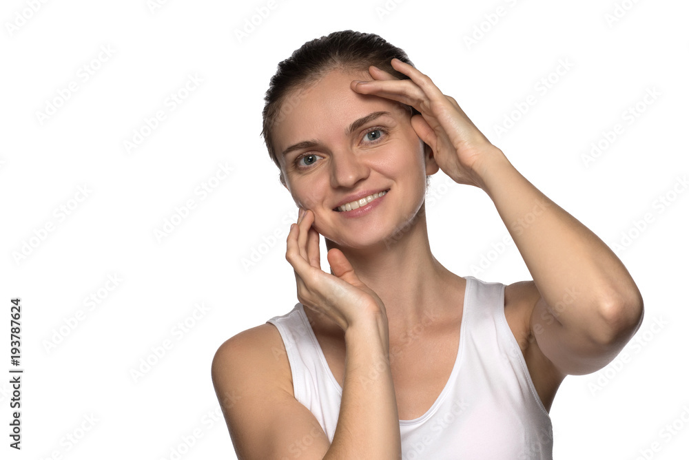 Massage, yoga, gymnastics or rejuvenating exercises for the face makes the girl own hands on a white background