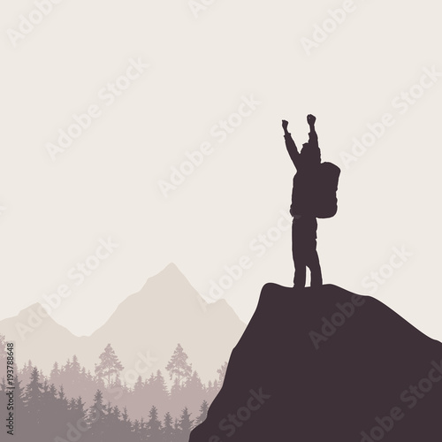 A tourist with a backpack standing on top of a rock rejoicing in win