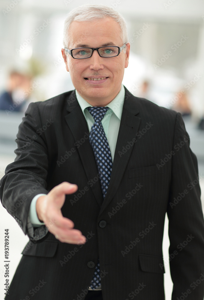 closeup of a senior businessman offering his hand for greeting. closeup of a senior businessman offering his hand for greeting.