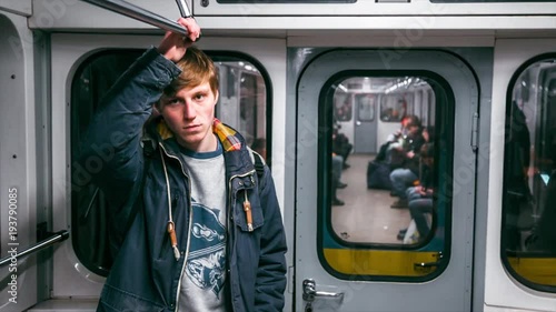 Young boy rides in the subway at night