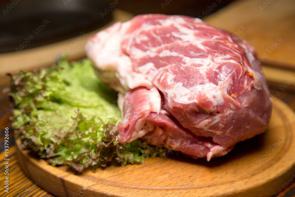Raw pork meat on wooden cutting board Raw pork meat on wooden cutting board